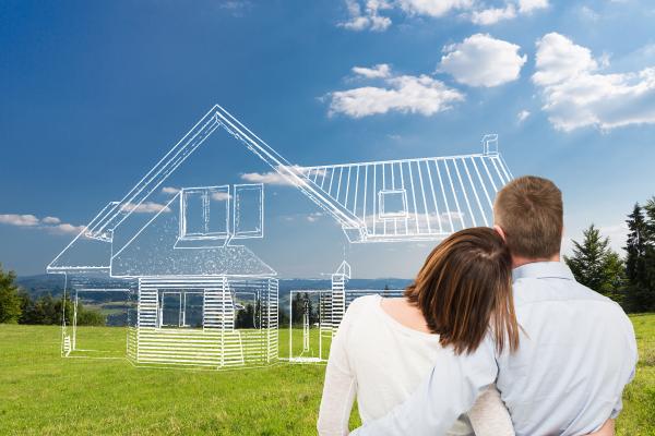 Image of couple in front of ghosted outline of new home