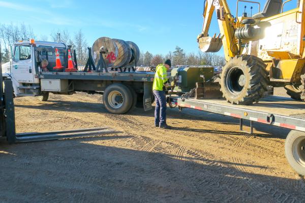 Warehouseman Kasey Kampfer secures a transformer for the construction of a new service.