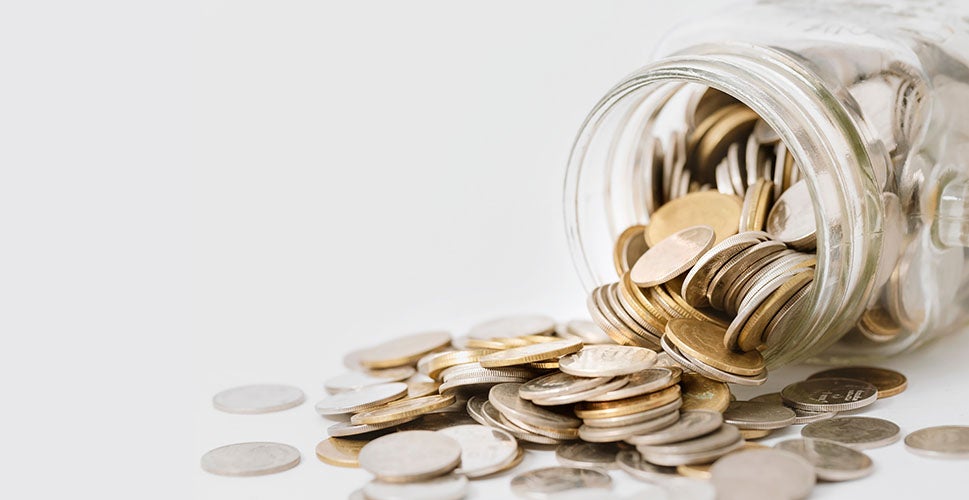 Jar with coins spilling out