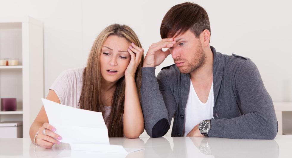 Young couple looking at bill 