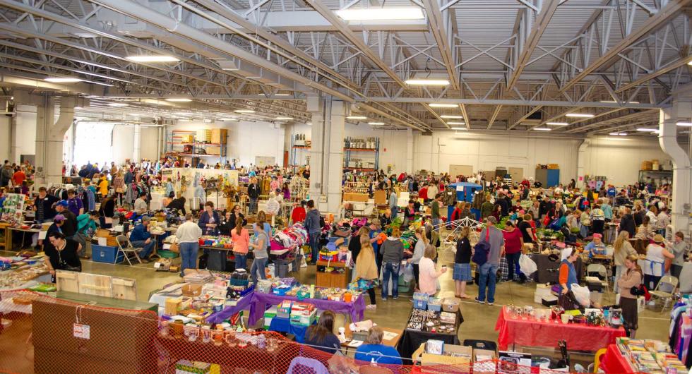 A panoramic view of garage sale booths set up in BEC's garage 