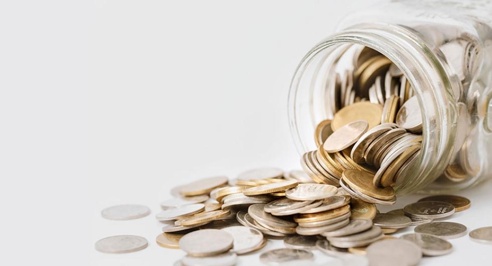 Jar with coins spilling out